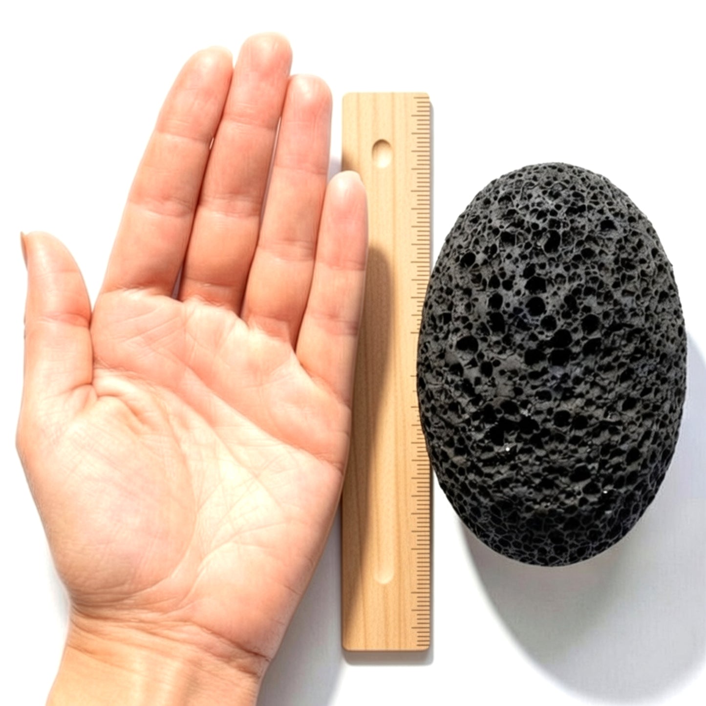Pumice stone size comparison with hand and ruler – large natural volcanic lava exfoliator for feet 4x3 inches